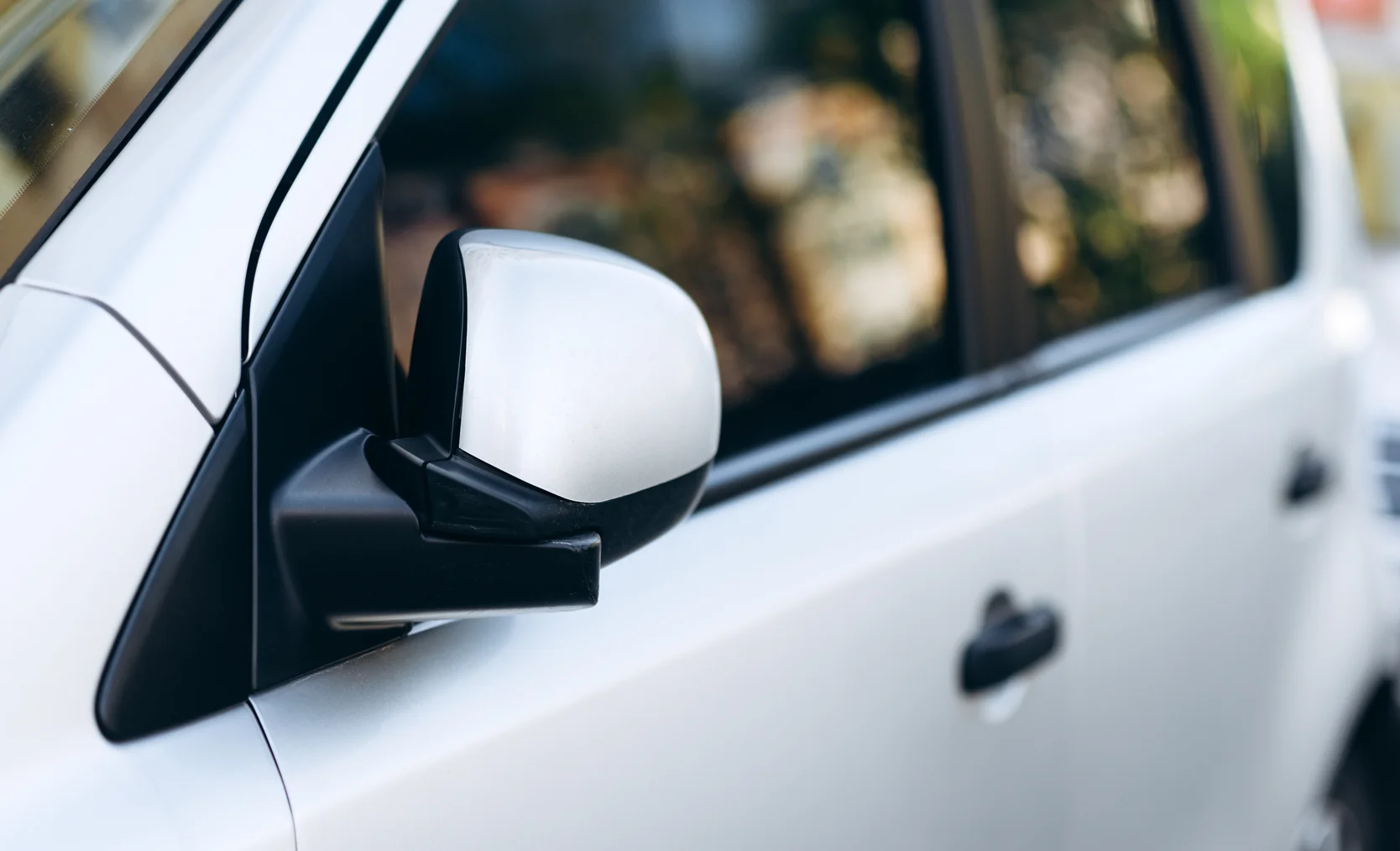 close-up-of-a-mirror-of-white-car-2024-10-18-09-29-45-utc.jpg