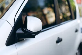 close-up-of-a-mirror-of-white-car-2024-10-18-09-29-45-utc.jpg